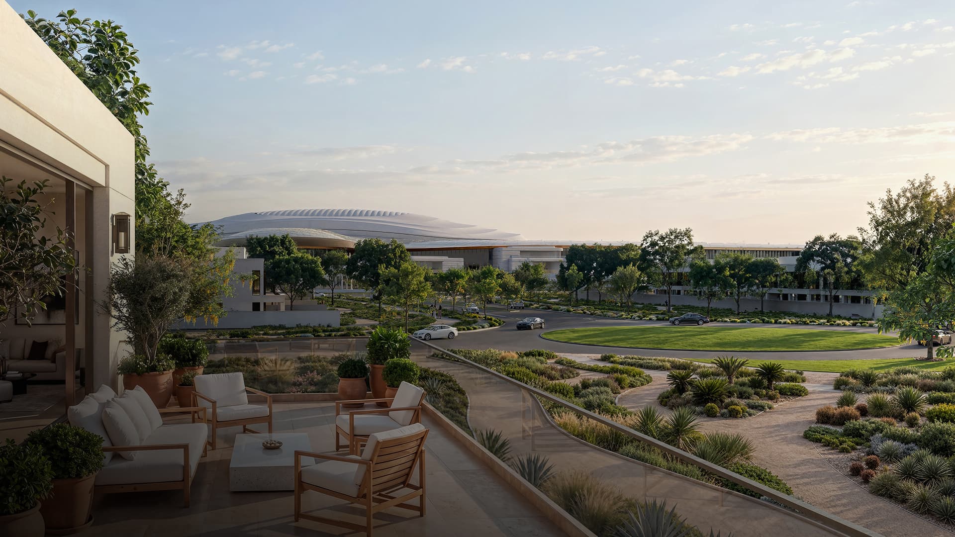 Wadeem Gardens by Modon — a villa terrace at dawn over the landscaped community and the Hudayriyat arena