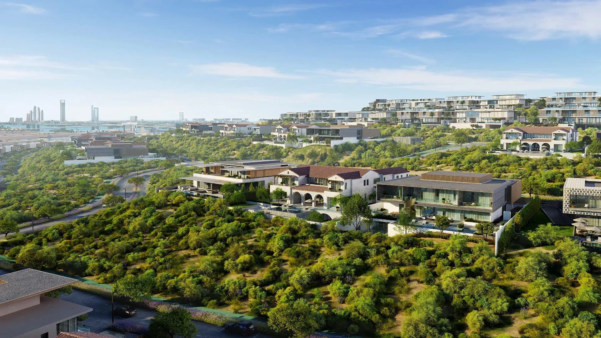Hudayriyat Island, Abu Dhabi — villas on the landscaped hillside with the city skyline beyond